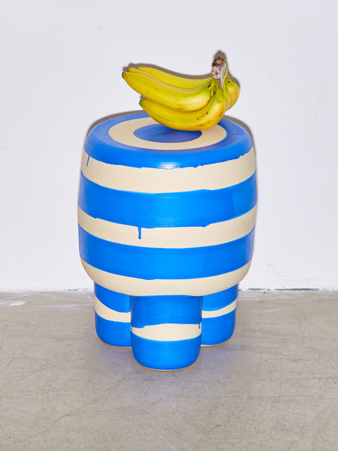 A bunch of bananas sits atop a blue Ceramic Milking Stool by Workaday Handmade.