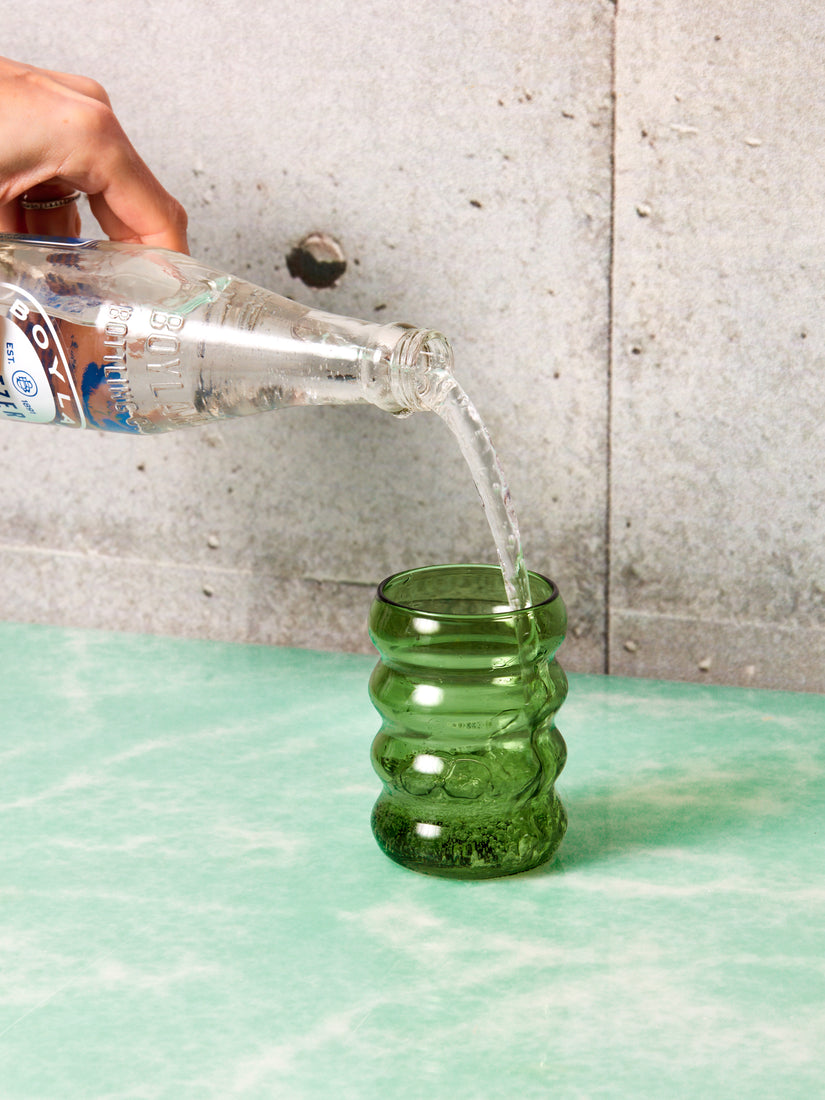 Seltzer being poured into a green Ripple Glass.