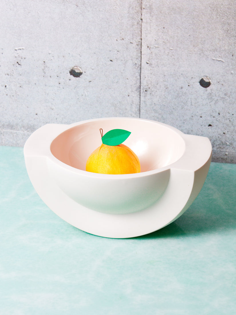 Saturn Ceramic Bowl by Light + Ladder with a Tops Malibu Orange Surprise Ball.