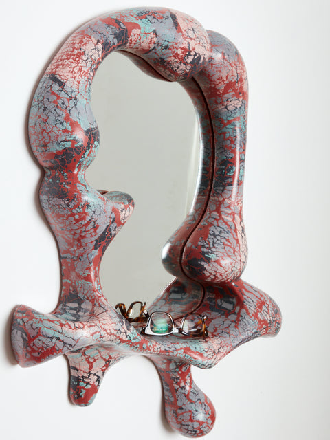 Concrete Cat Iris Mirror in red, blue, charcoal, and pale pink tones.