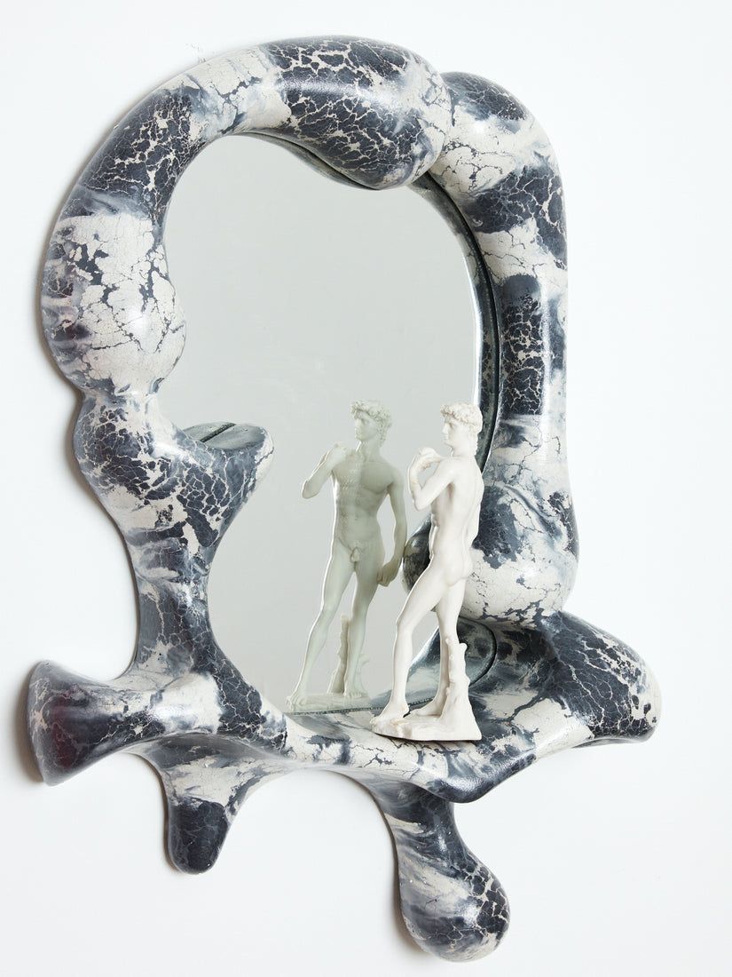 Black and White Iris Mirror by Concrete Cat with a statue of David on its ledge.