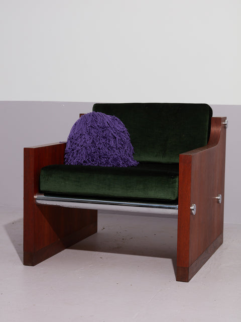 Purple Crochet Pillow by Huldra of Norway on an armchair.