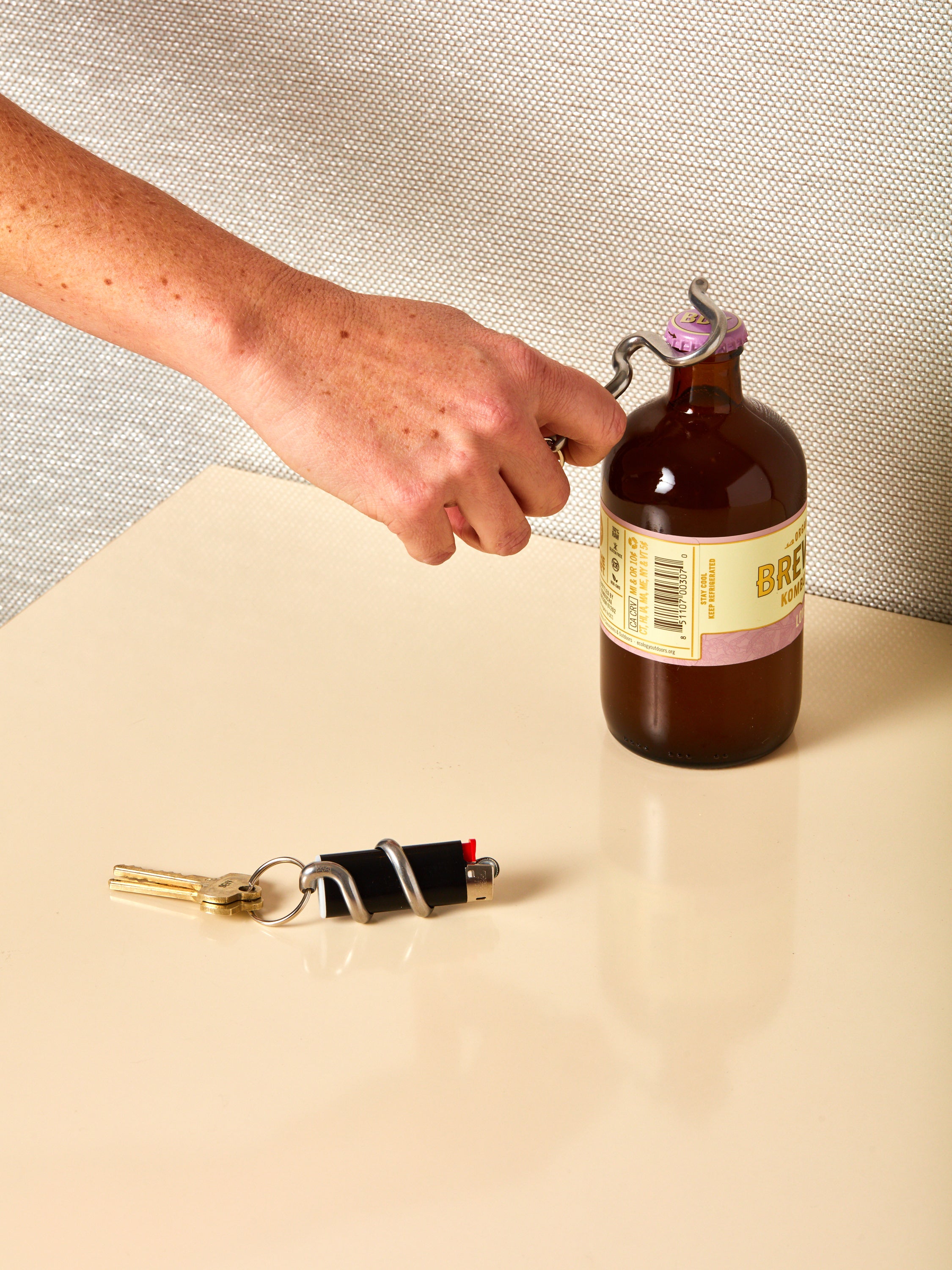 A Serpent Lighter Holder keychain and a Serpent Bottle Opener keychain in use!