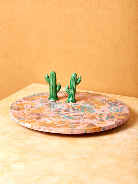 Ceramic cactus salt and pepper shakers sit atop a Concrete Cat Lazy Susan.