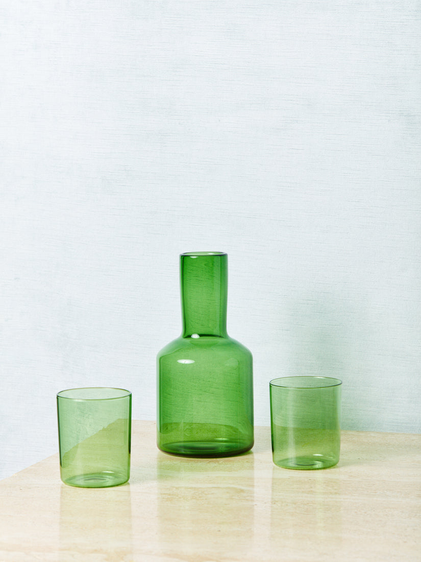 A green bedside carafe with two cups.