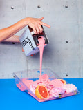 Barragan-cito pink paint being poured into a roller tray full of pink fruits and flowers.