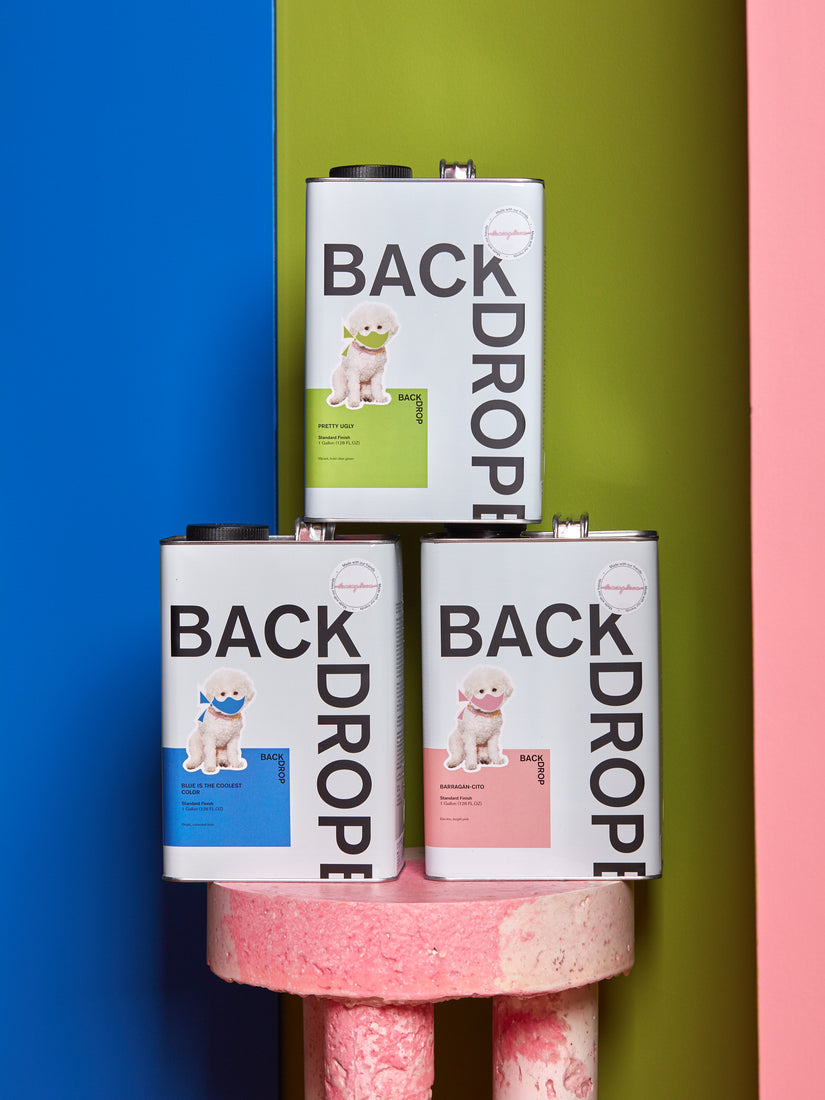 Coming Soon and Backdrop Paint collaboration paints stacked in a pyramid.