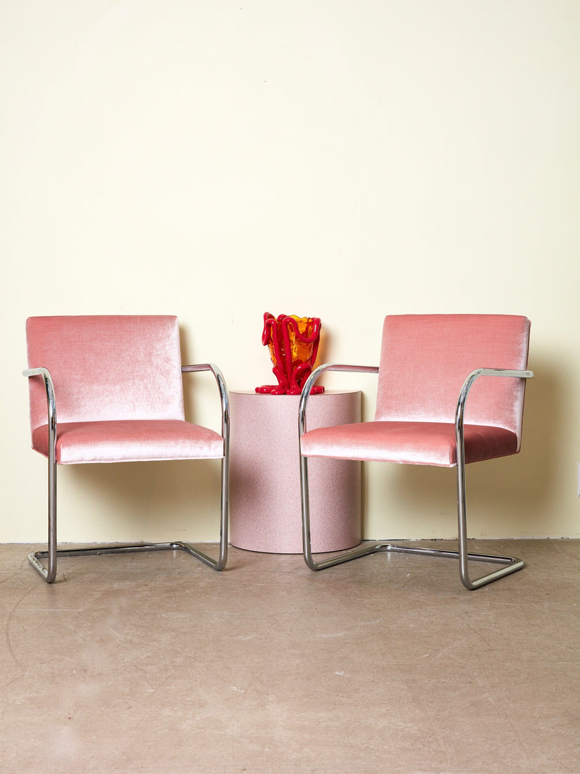 A pair of pink vintage Brno Chairs, a pink side table, and an Indian Summer Vessel.