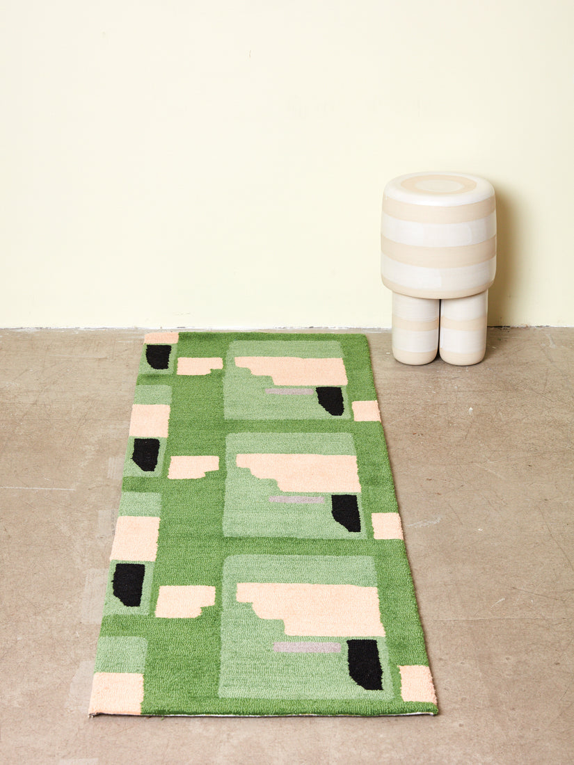 Ceramic Milking Stool in white next to a 2x6 Purple Noon runner rug by Cold Picnic.
