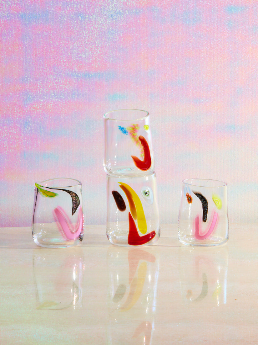 Four medium glass face vessels by degen with varying multicolored faces.