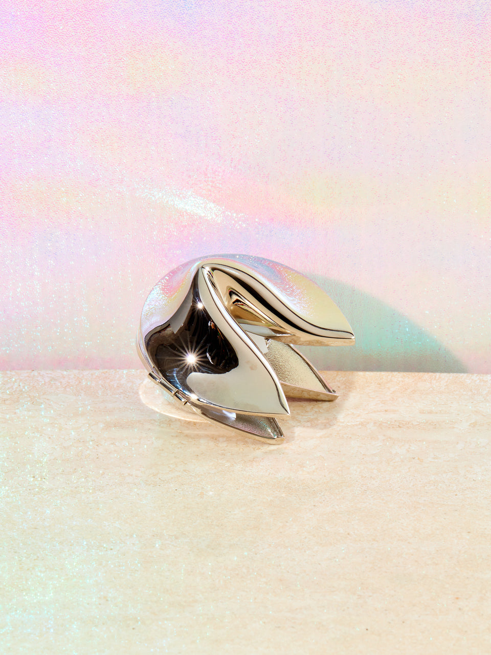 Chrome fortune cookie box slightly ajar.