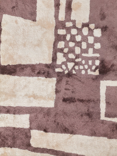 A close up view of the Battenberg Rug by Cold Picnic that highlights the depths of each color as well as the velvety sheen of the bamboo silk.