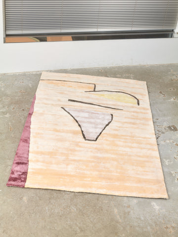 Sherbet Rug by Cold Picnic on a concrete floor.