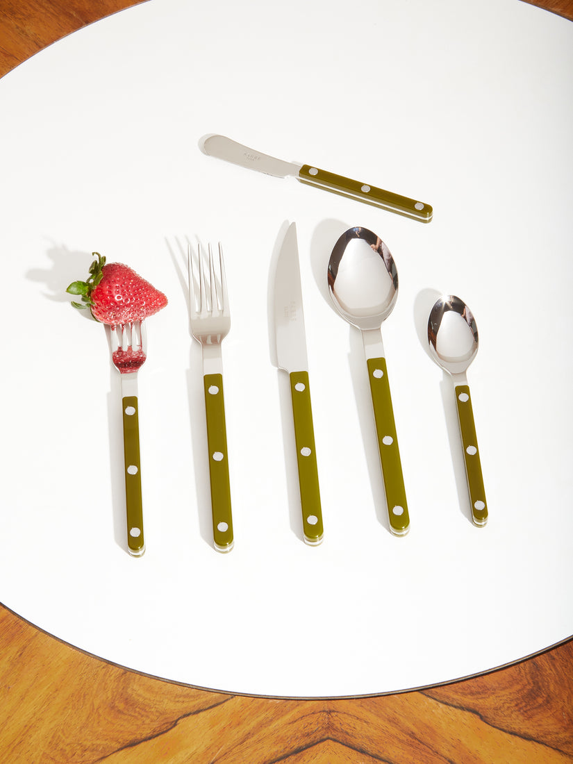 Six pieces of Bistro flatware by Sabre in olive. The salad fork has a strawberry on its prongs.