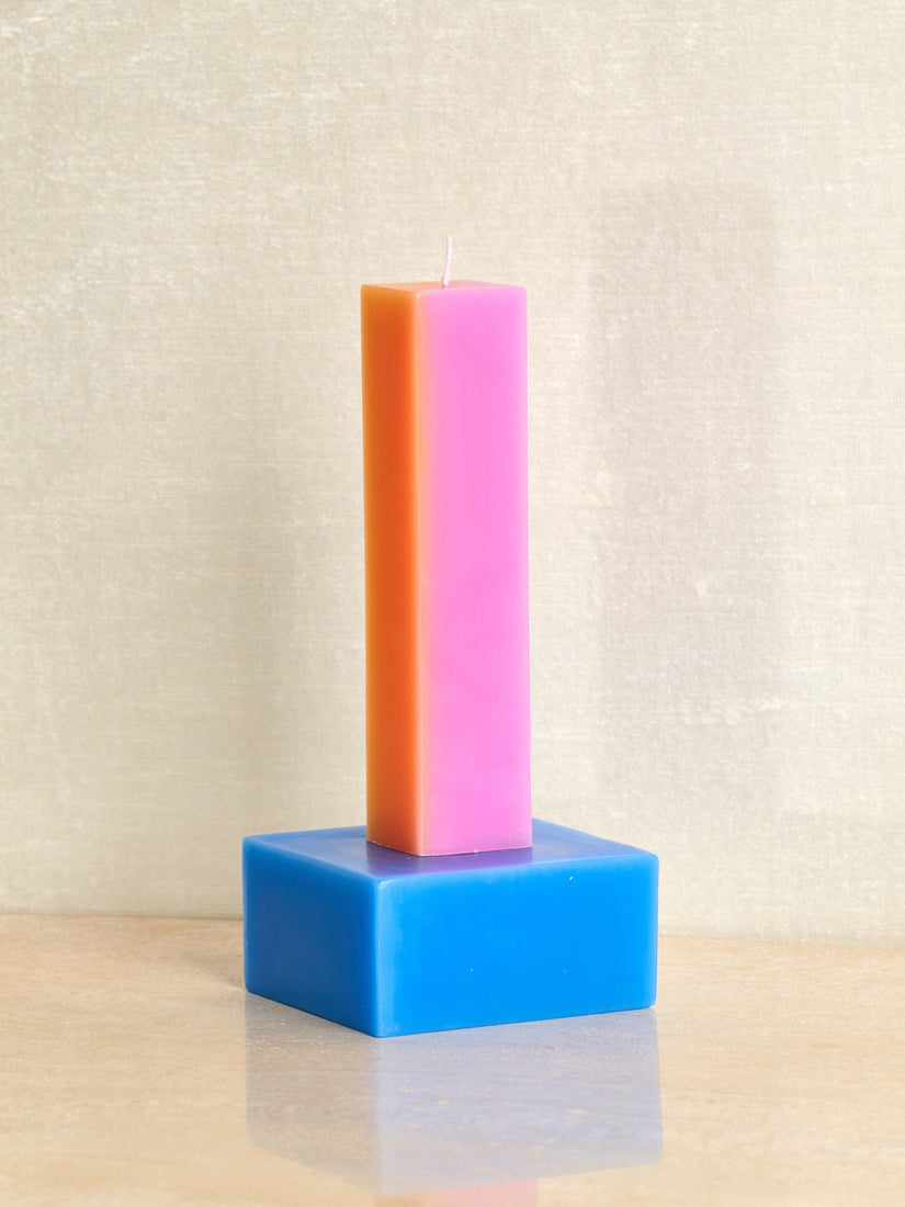 Happiness Candle by Yinka Ilori in Pink/Orange with Blue base.