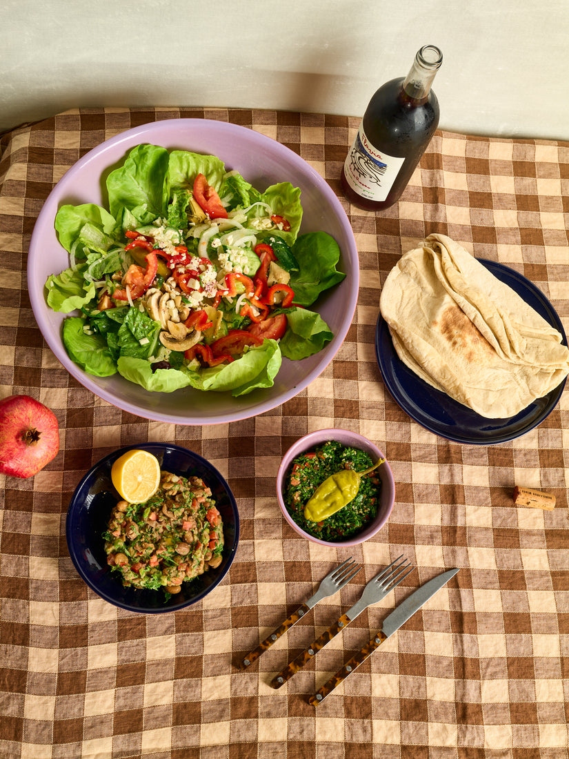A birdseye view of a Mediterranean dinner spread on Trame ceramic dinnerware.