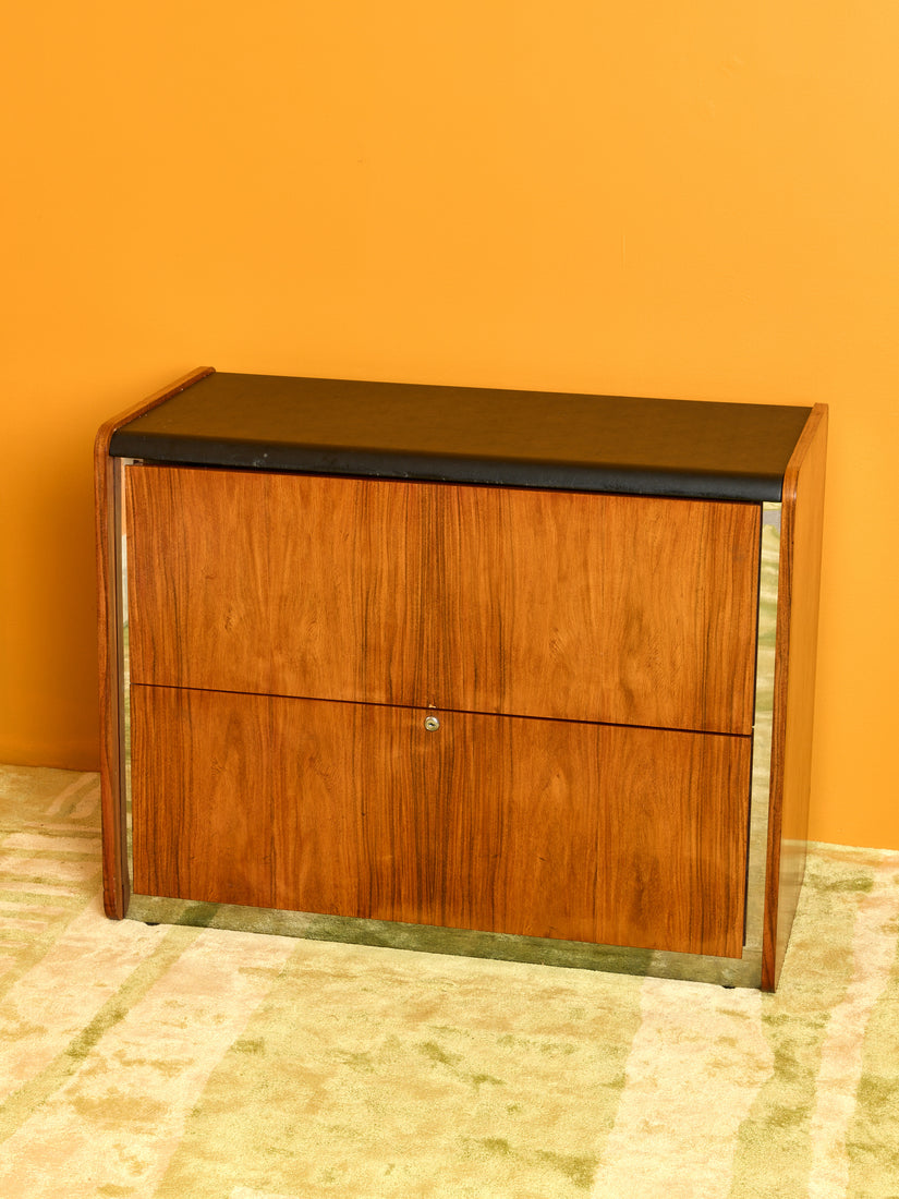 Vintage Storage Cabinet by Ste. Marie and Laurent, wooden cabinet with black top and chrome accent.