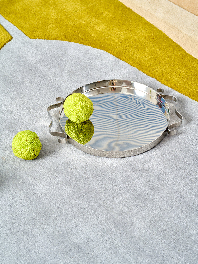 The Squiggle Tray by Sophie Lou Jacobsen atop an abstract rug.