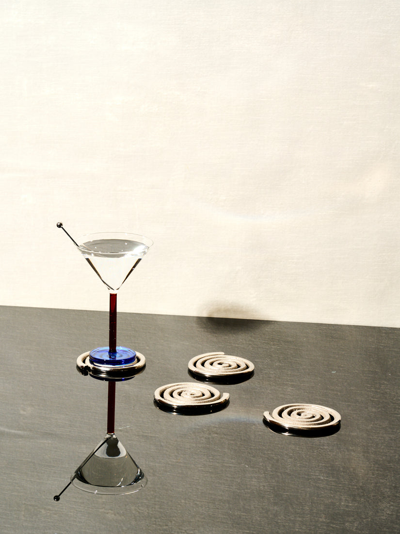 Set of 4 Spiral Coasters by Sophie Lou Jacobsen and a single Piano Cocktail Glass.