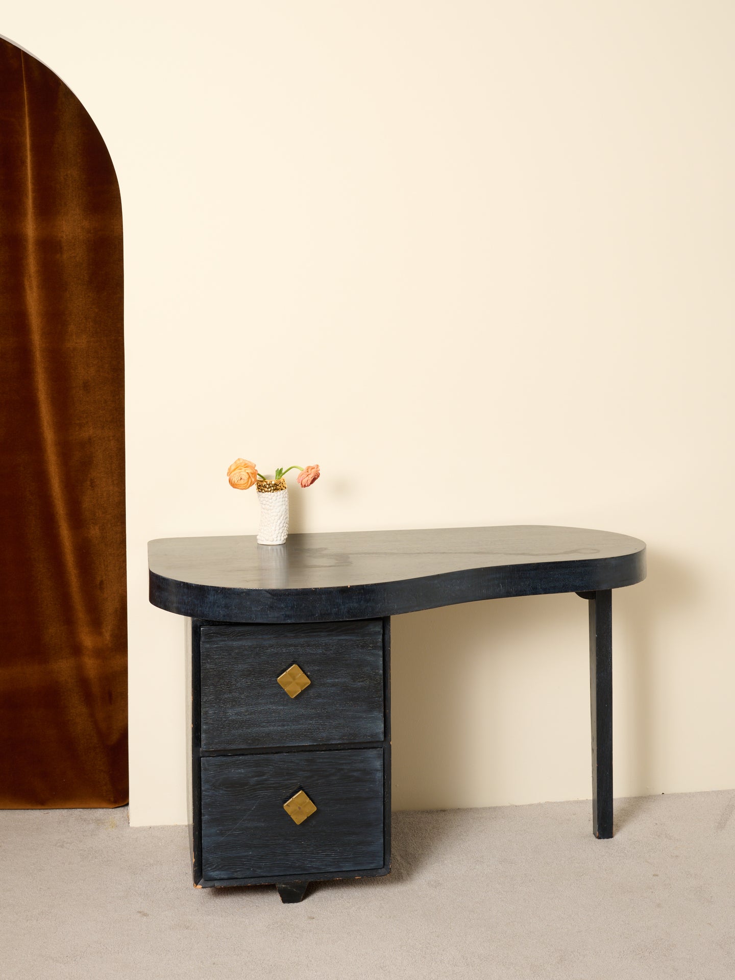 Vintage wooden desk with a curved top and two drawers.