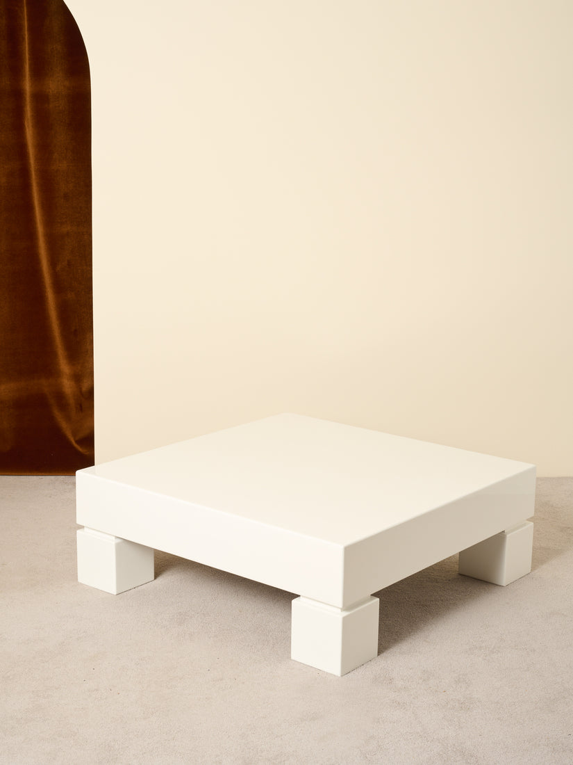 White Lacquered Coffee Table with cube legs.