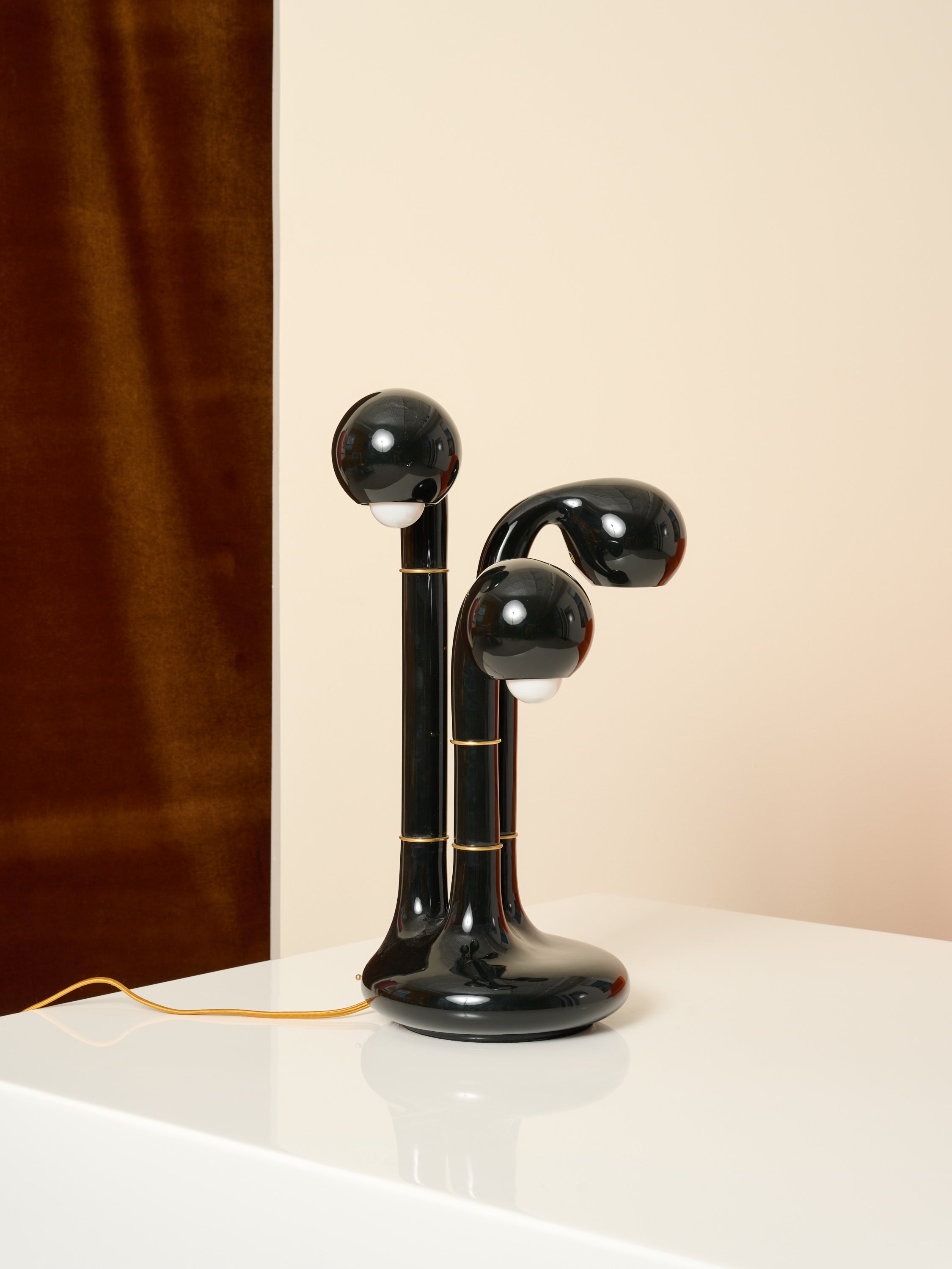 Picture of Three Globe Entler Lamp on a white table. 