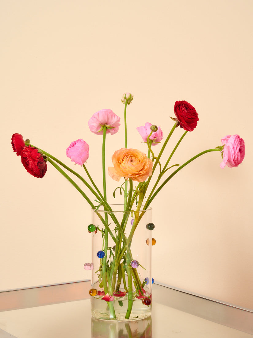 Dot Vase by Maison Balzac full of multicolored ranunculus.