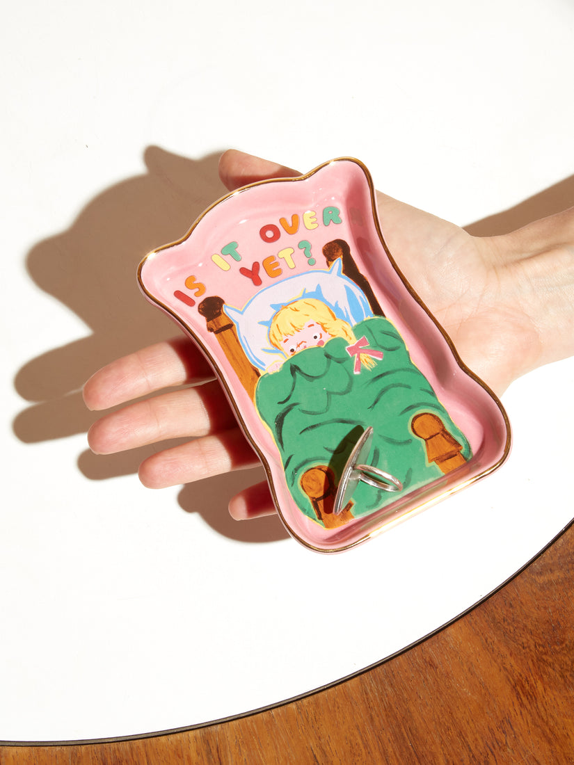 A Trinket Tray with illustration by Magda Archer that shows a blond child in a bed and the text "IS IT OVER YET?"