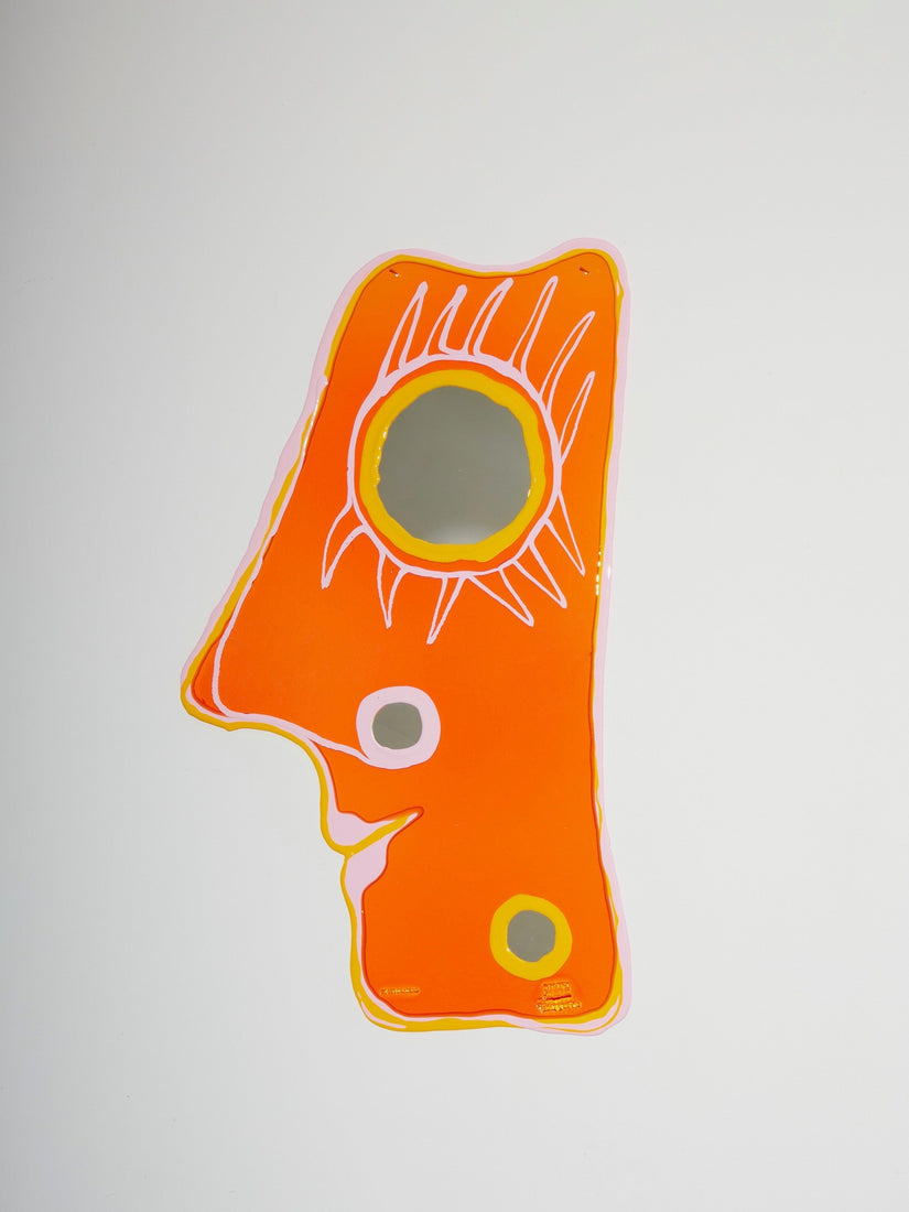Handmade resin mirror with three round mirrors that make up an abstract face. 