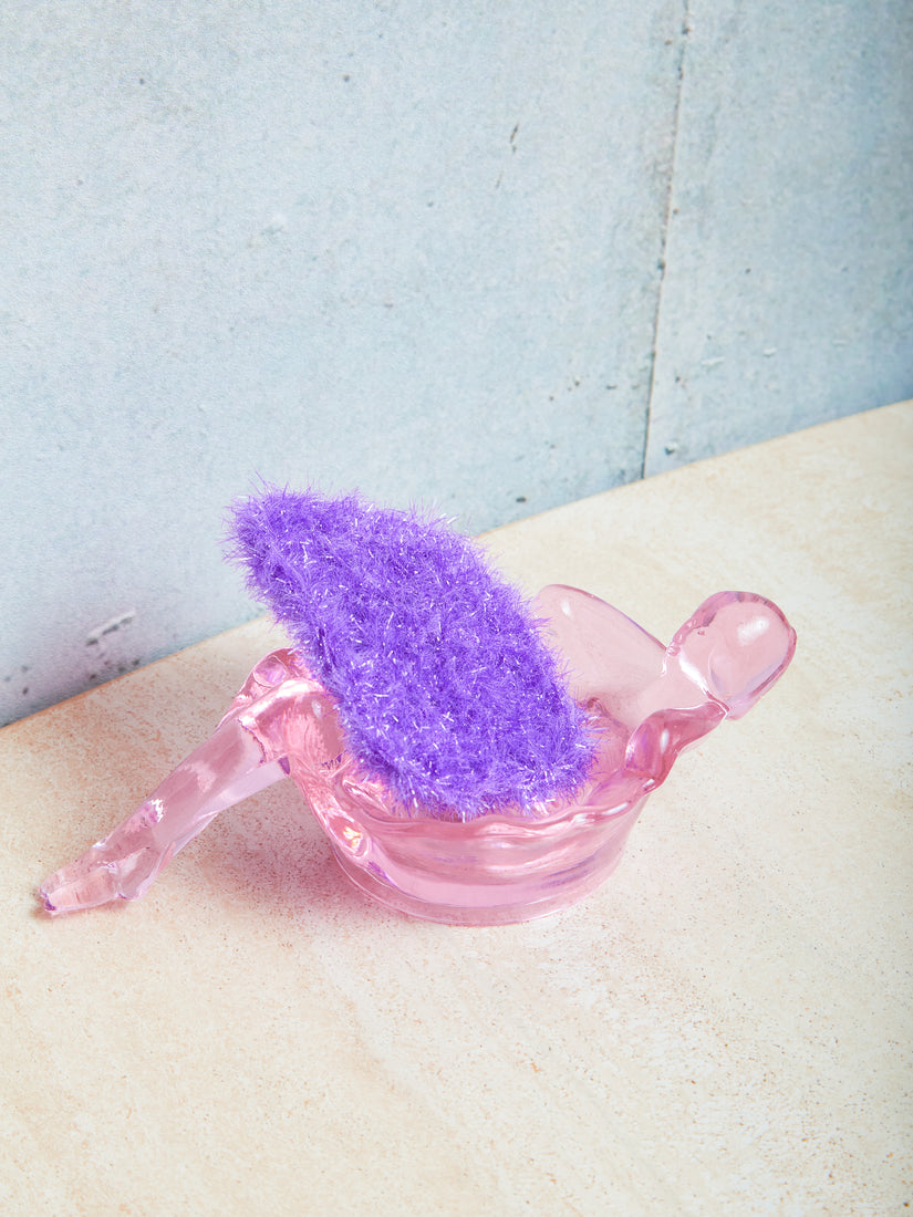 A single purple sponge inside of a rose bathing lady dish by Mosser.