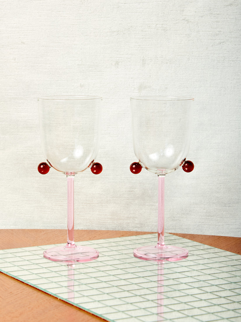 A pair of pink and amber Pompom Wine Glasses by Maison Balzac.