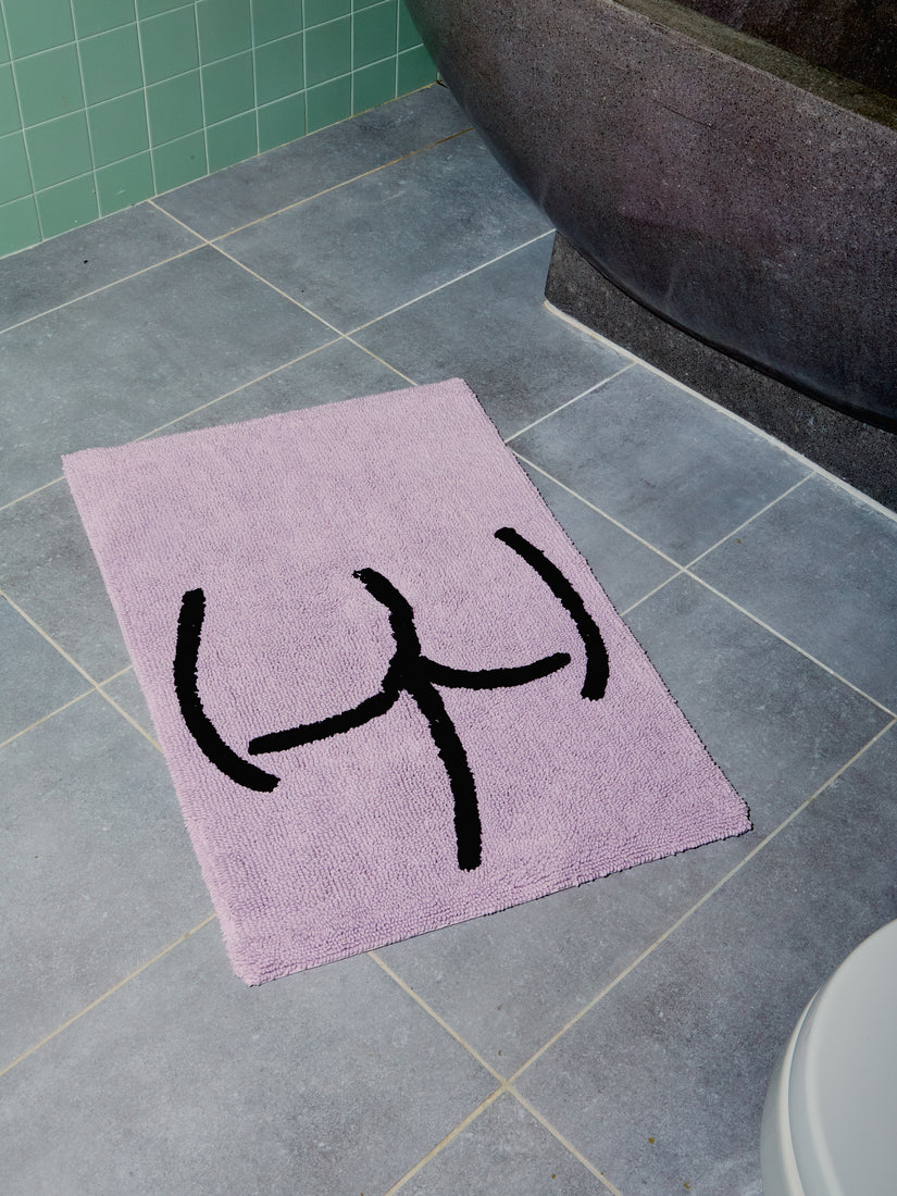 Tushy Bath Mat by Cold Picnic in lavender with black graphic butt design.