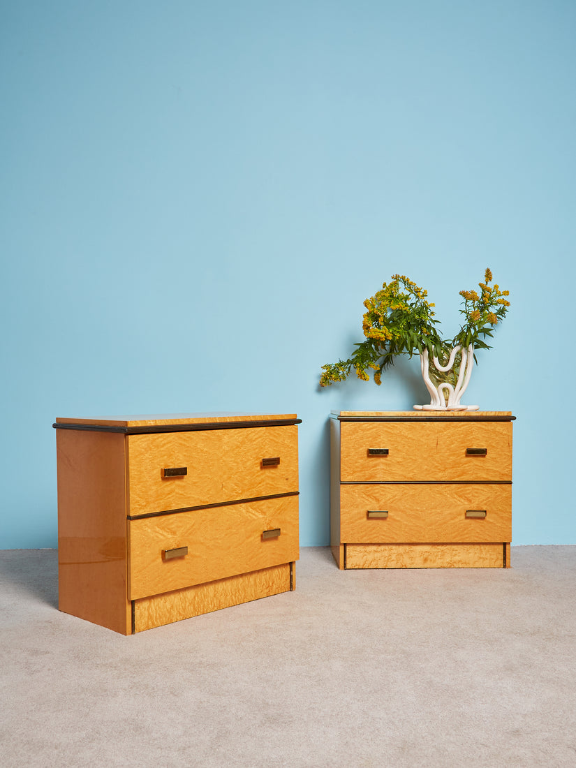 Nightstands with brass hardware and dark wood accents.
