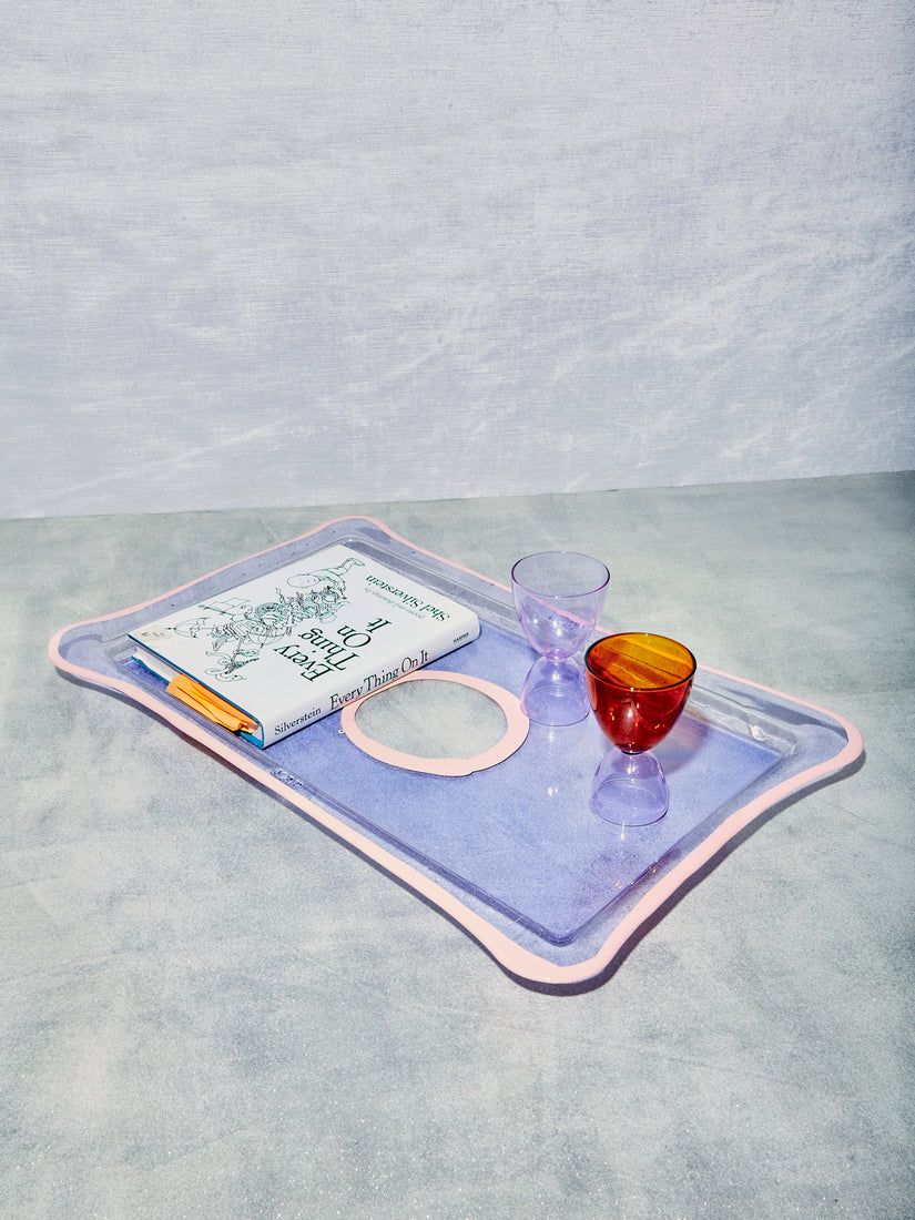 A large rectangular tray in lavender pink with a book, and 2 MaMo cocktail glasses.