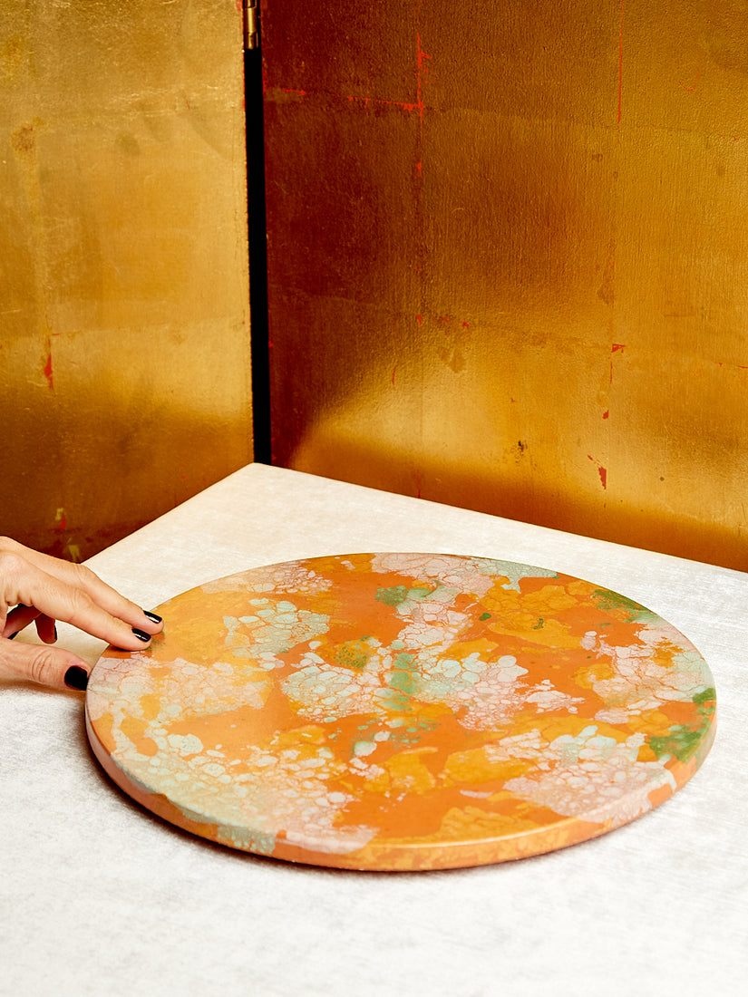Mostly orange Concrete Lazy Susan with pattern of creams, pinks, and greens.