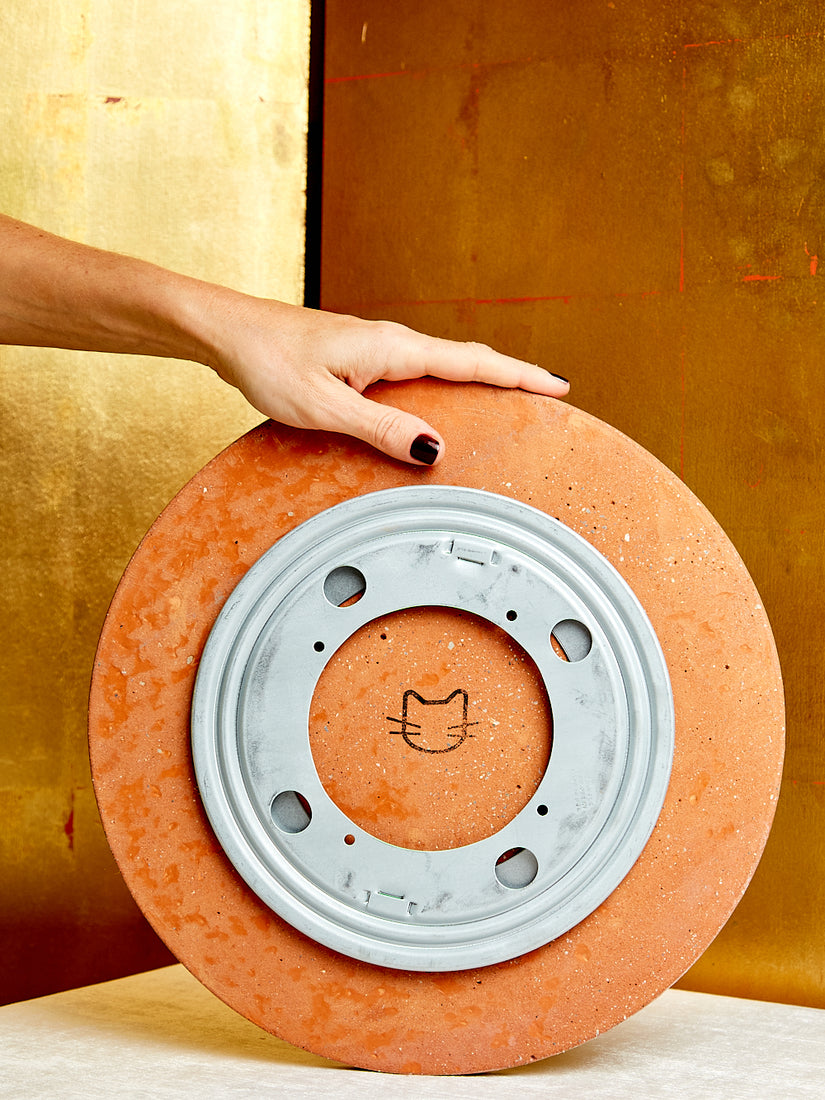 The underside of the lazy susan, showing its rotating mechanism and Concrete Cat logo.