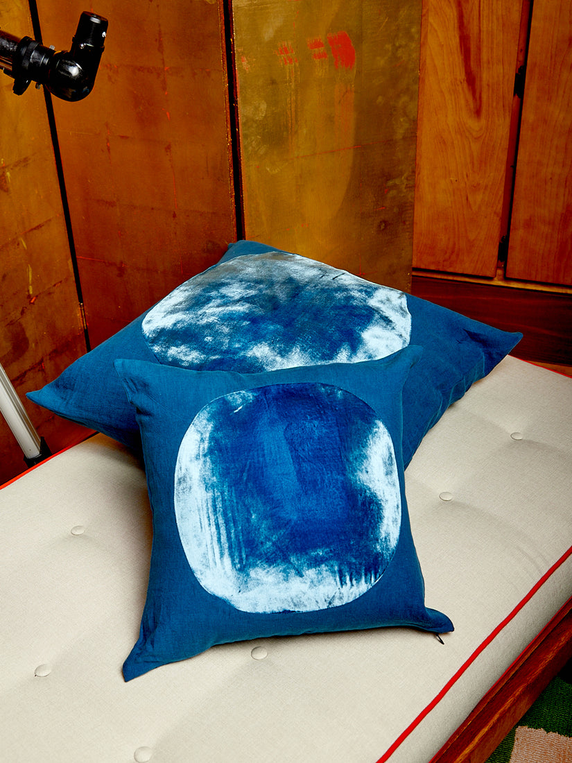 A medium and large blue Velvet Circle Pillow.