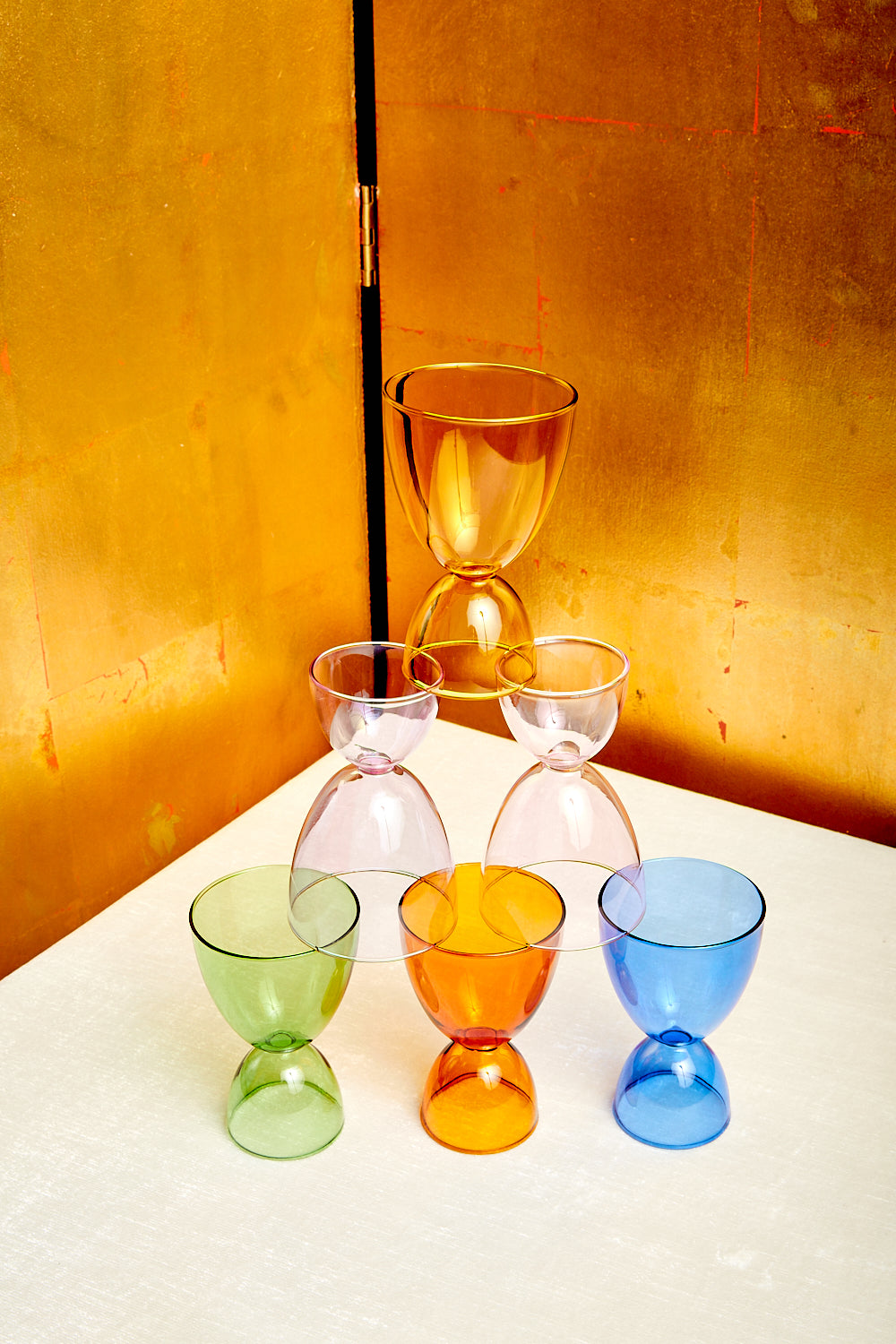 A pyramid of Mamo's cocktail glasses in 6 different monotone colorways.