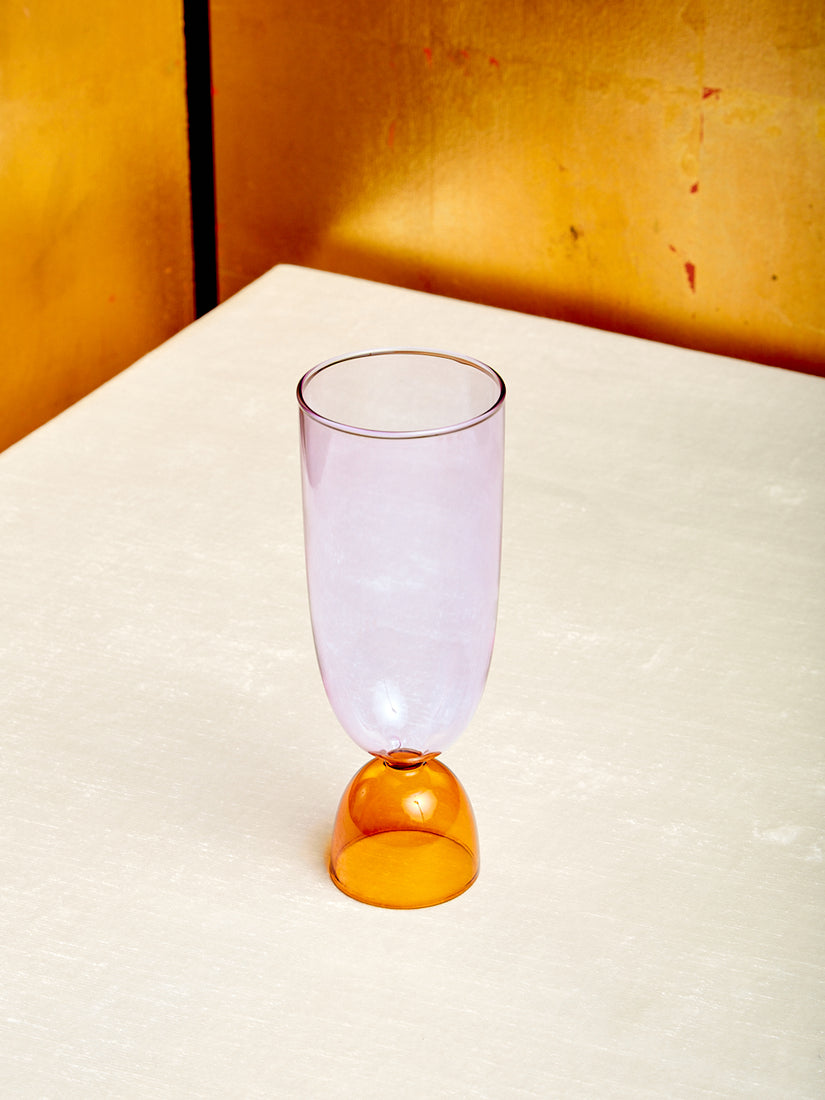 A lavender top amber bottom Harry Highball Glass.