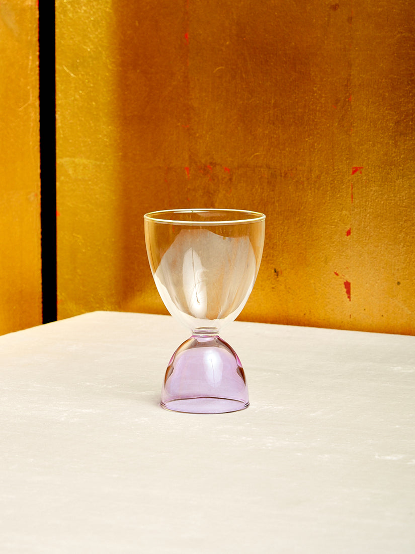 A clear top lavender bottom cocktail glass.