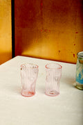 A pink pair of sake glasses by Iannazzi Glass.