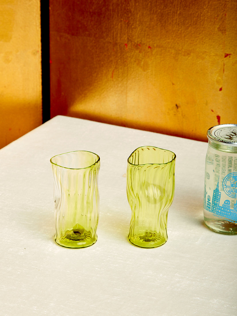 A pair of green sake glasses by Iannazzi Glass.