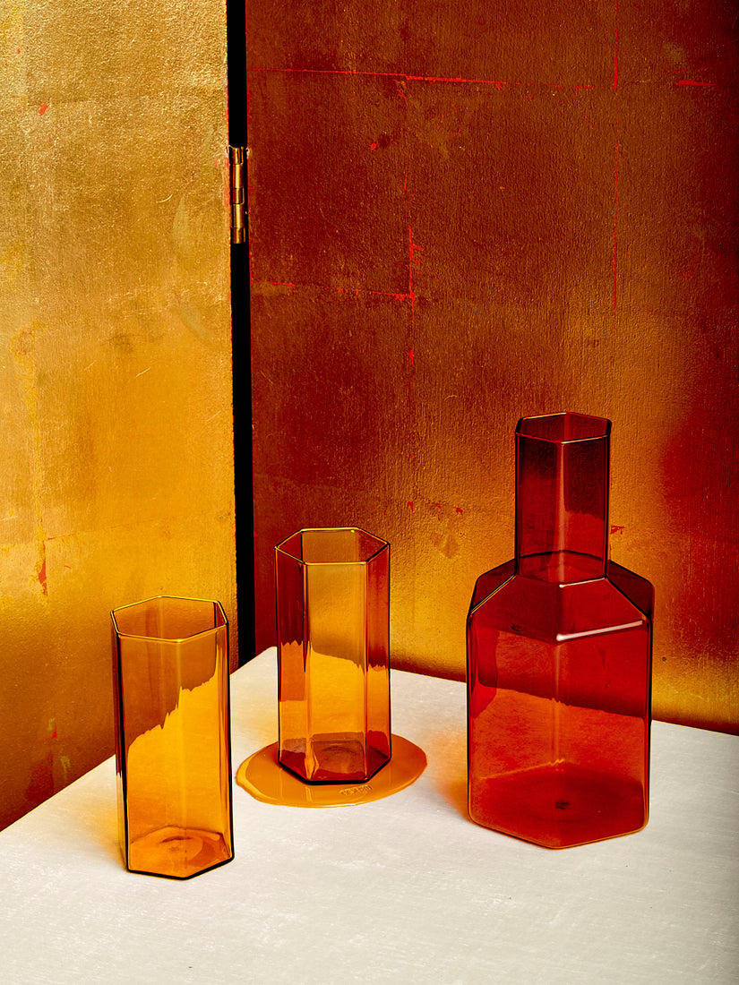 A pair of honey Coucou Glasses and an amber Coucou Decanter by Maison Balzac.
