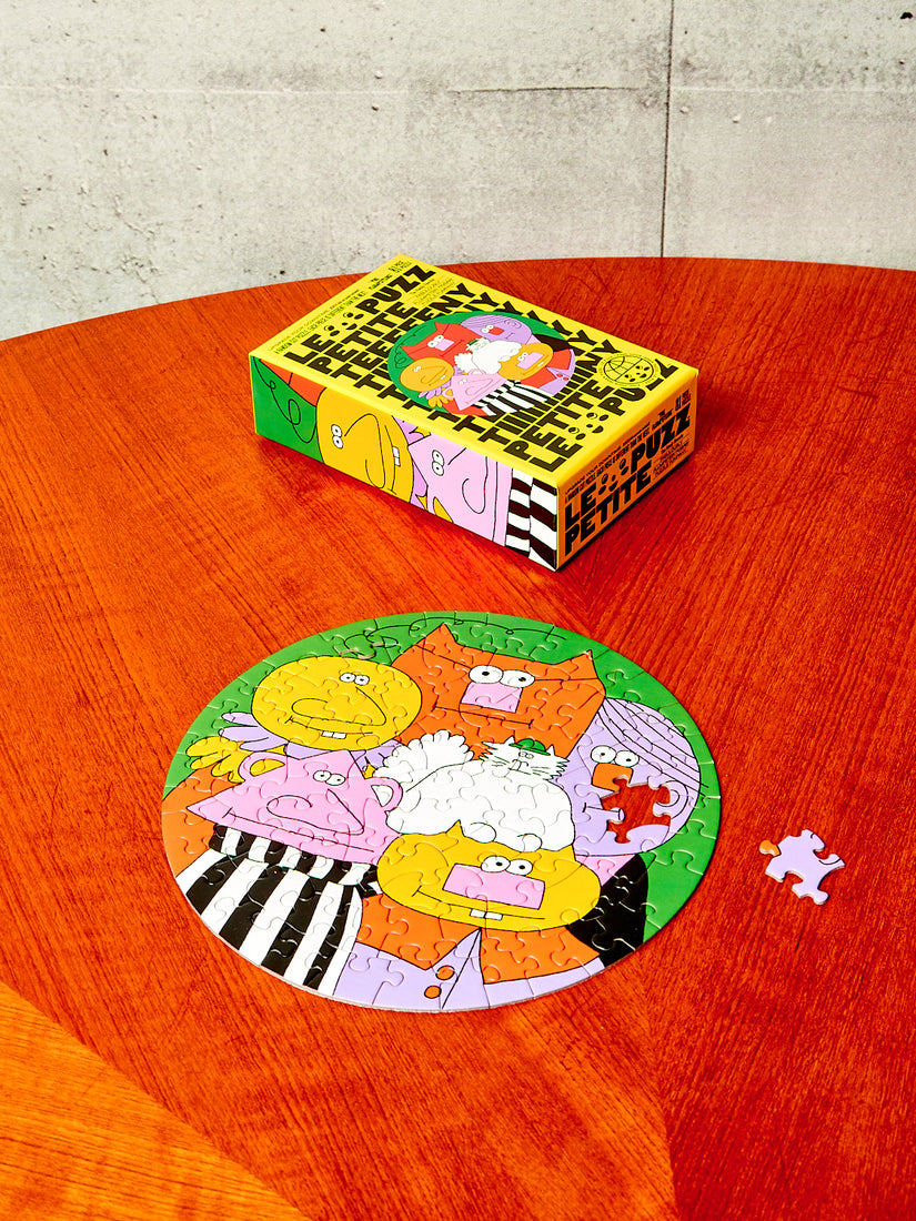 The Flumpsteins Puzzle completed except for one piece sitting next to its box.