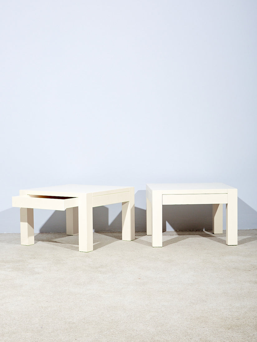 Pair of side tables by Gae Aulenti with hidden drawers. One drawer is slightly pulled out.