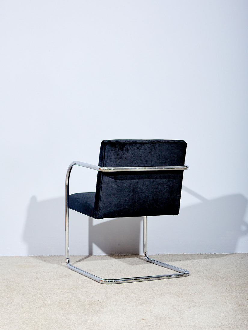 Back side of the chair showing its continuous chrome cantilever tubular frame.
