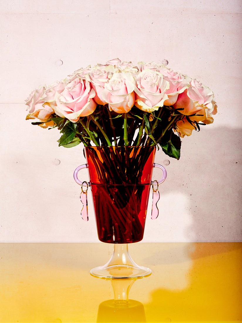 A Happy Vase by Maison Balzac full of pink roses.