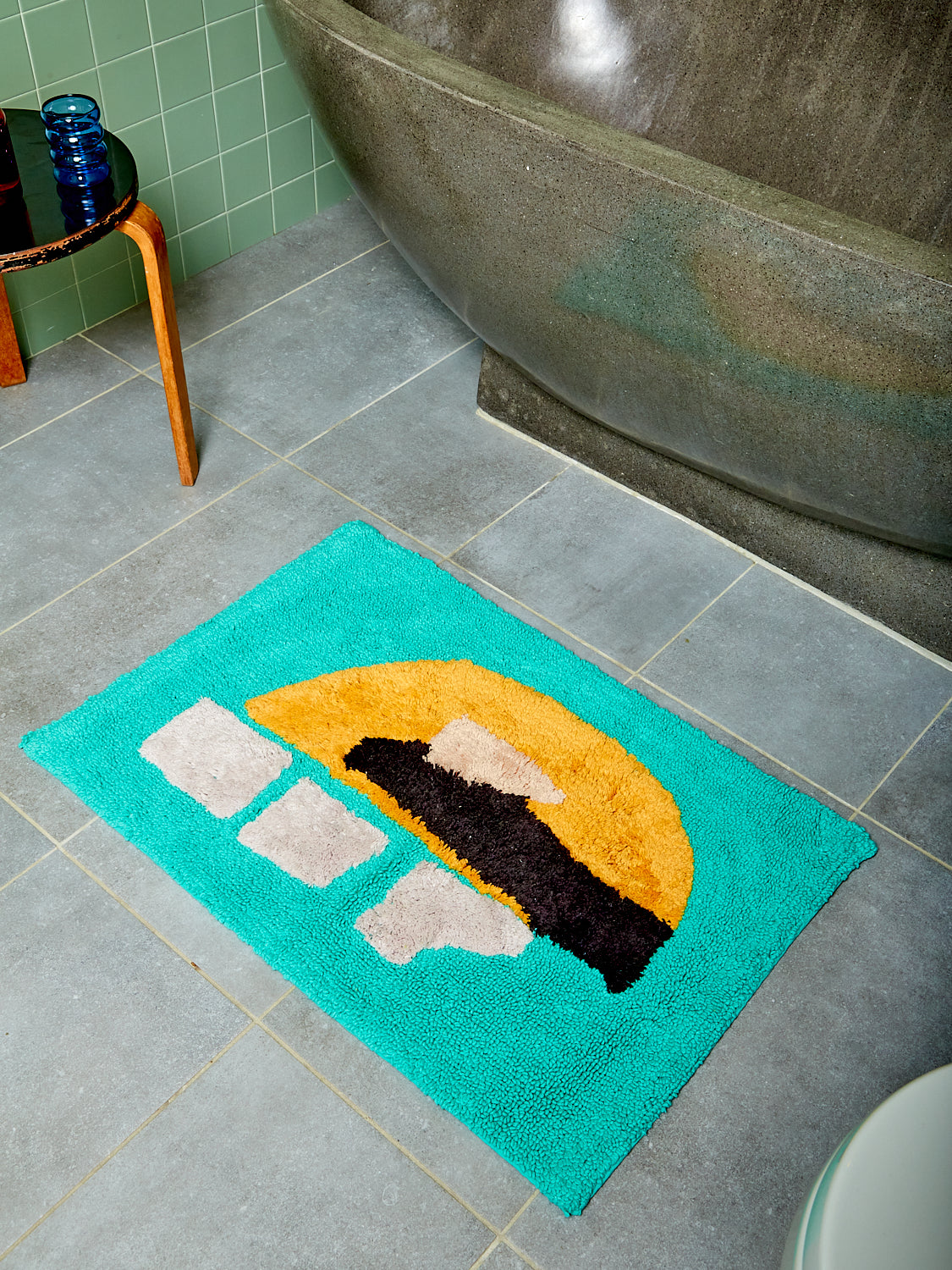 Limelight Bath Mat in front of a stone tub.