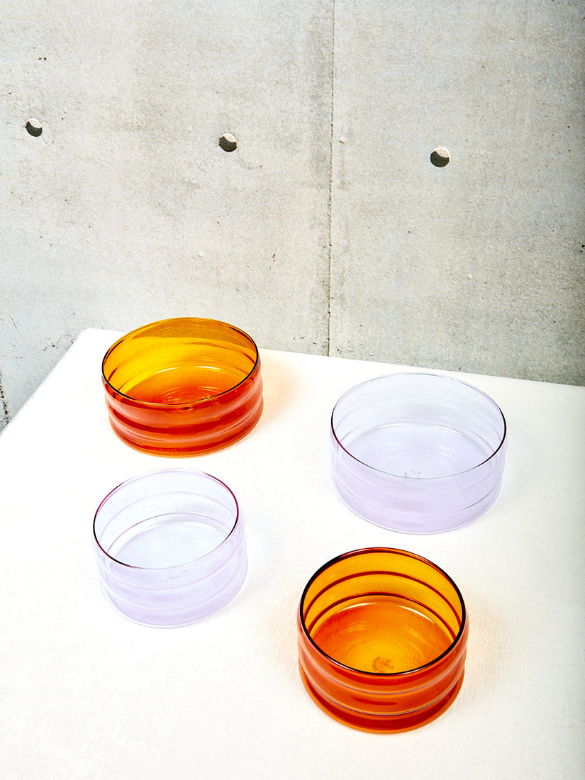 Medium amber, medium lavender, small amber, and small lavender Ripple Bowls by Sophie Lou Jacobsen.