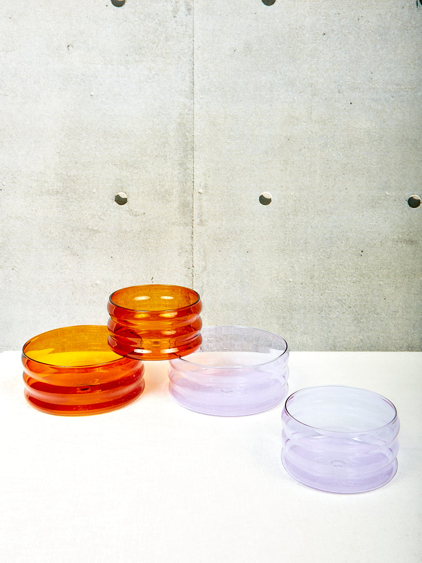 Ripple Bowls by Sophie Lou Jacobsen in two colors, amber and lavender, in two sizes each.